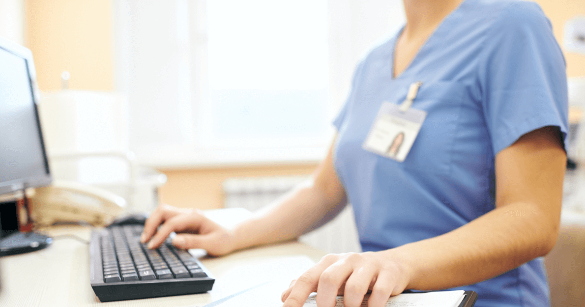 Nurse with hands working on at a computer - HealthStream Checklist