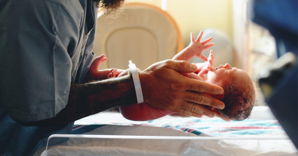 Father holding an infant in the hospital - Neonatal Resuscitation HealthStream